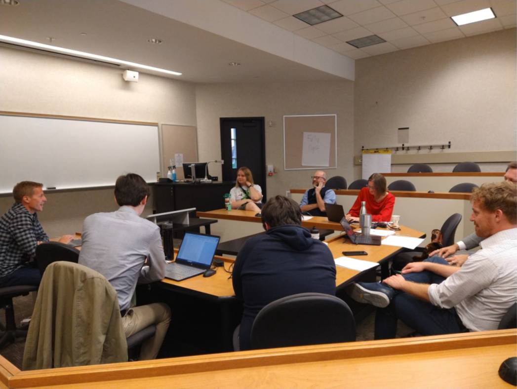 Organizers sitting at tables collaborating on the Great Lakes History Conference